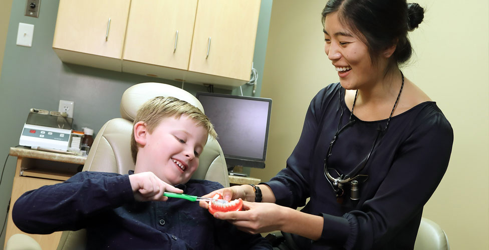 Dentist explaining procedure to young patient