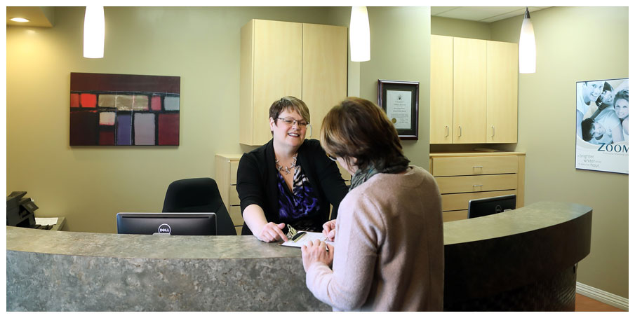 Receptionist greeting patient